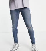 COLLUSION 001 - Super skinny-jeans med flænger på knæene i mellemvasket blå